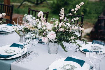 Wedding table decoration in rustic style. Wedding flowers.