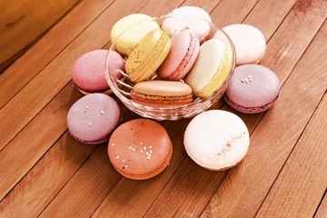 French pastries multicolored macaroon on a wooden background
