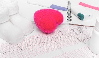 Electrocardiography, close-up. Notebook pregnant. The result of consulting a doctor.