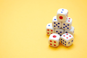 White dices on yellow background. Selective focus