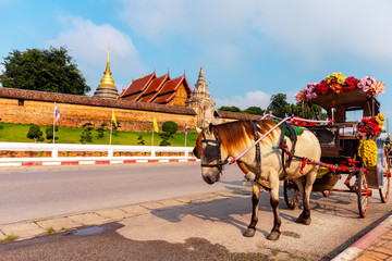 Naklejka na ściany i meble The horse carriage in Lampang at Wat Phra That Lampang Luang , Lampang province in LAMPANG THAILAND.