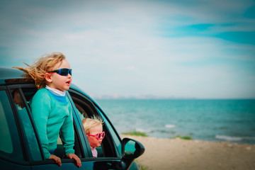 happy kids enjoy travel by car at sea