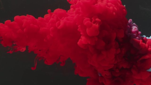 Red paint mixing with blue