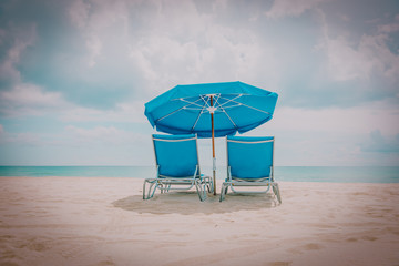 Two beach chairs on tropical vacation at sea