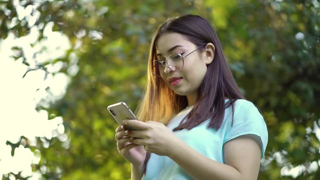 Beautiful millennial girl using wifi send email or sharing in social media or typing message on touch screen. Slow motion video