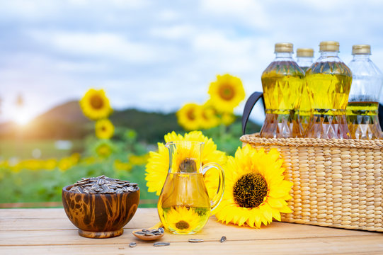 Wicker basket with sunflower, sun flower seed and  bottles of oil on the background of the farm