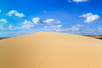 Landscape of white sand dune with beautiful clear sky with cloud at Mui Ne , Vietnam.