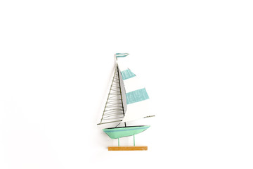Miniature toy boat on white background. Flat lay, top view