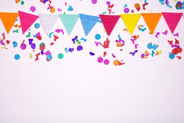 Confetti and garland on white background