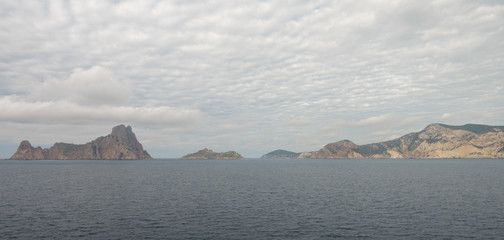 The island of es vedra from behind from a boat