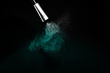 Deep ocean powder color splash and silver brush for makeup artist or beauty blogger in black...
