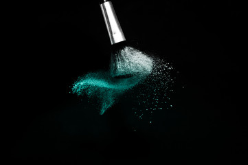 Deep ocean powder color splash and silver brush for makeup artist or beauty blogger in black background, look like a look like a cold and calm mood.