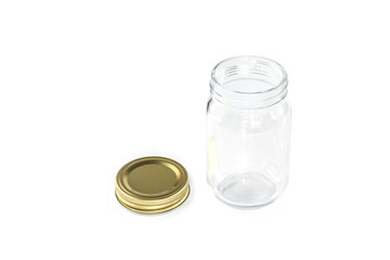 Empty jar of golden cap is open on a white background.