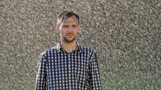 Portrait of sad man standing under the rain