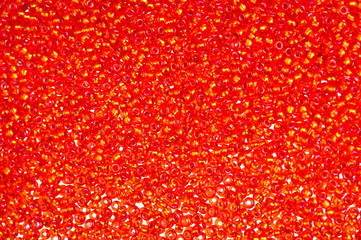 Flame-orange glass beads background - closeup beads texture