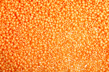 Flame-orange glass beads background - closeup beads texture
