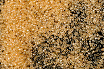 Flame-orange glass beads background - closeup beads texture