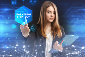 The concept of business, technology, the Internet and the network. A young entrepreneur working on a virtual screen of the future and sees the inscription: marketing strategy