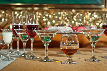 Glass glasses with colored drinks on the table. alcoholic drinks at the buffet