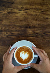 Hands holding coffee cup heart cup