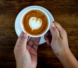 Hands holding coffee cup heart cup
