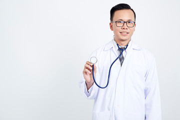 Fototapeta premium Doctor holding stethoscope on white background