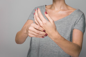Parkinson's disease symptoms. Close up of tremor (shaking) hands of Middle-aged women patient with...
