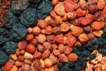 Healthy food. Background of dried fruit. Rows of dried apricots, pears, raisins, apples, prunes