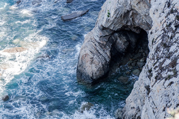 panoramic of coast in spain with blue sea, rocks and vegetation on sunny day