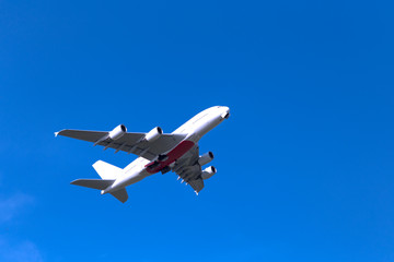 Transport airplane fly over the clear blue sky.