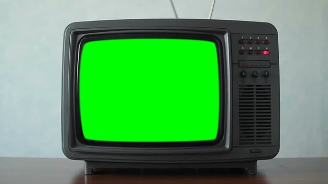 Old TV with a green screen in the room