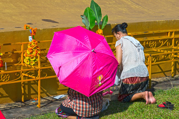 laos, ventiane : haw pha kaeo : two women praying