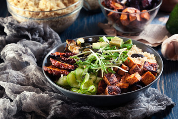 Colorful buddha bowl with quinoa and roasted and fresh vegetables