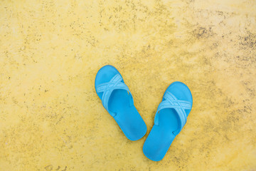 Pair of rubber sandal flip flop footwear on the beach with copy space.