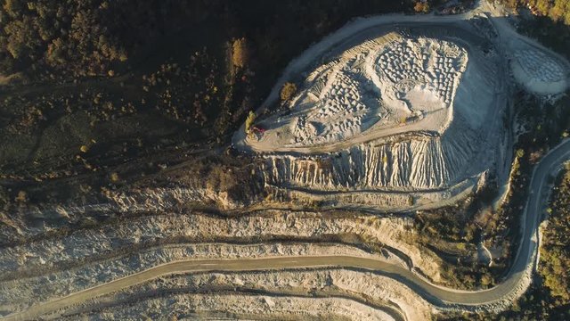 Top view of stepped quarry. Shot. Quarry working by method of open vertical benches. Mining industry concept