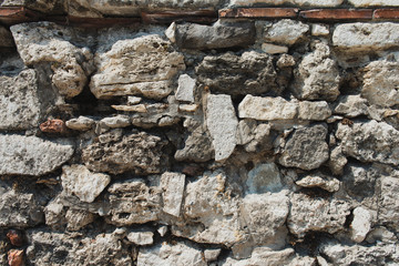 Ancient wall made of stones texture. Aged vintage wall background. Stones of different size and shape.