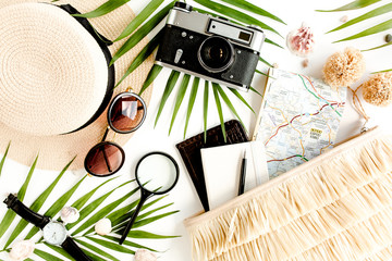 Traveler accessories on white background with retro camera, straw hat, bag, sunglasses, map and...