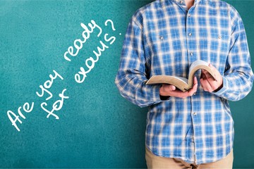 Man reading old heavy book on background