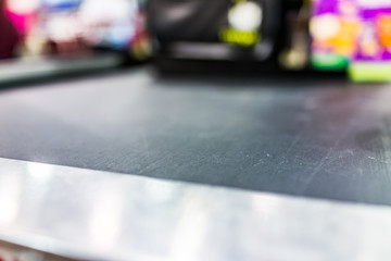 Macro closeup of grocery store checkout aisle conveyor belt business blurred background abstract...