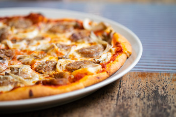Fresh pizza with tomatoes, cheese and sausage