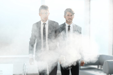 businessmen leave the office in smoke