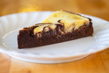 Fototapeta na wymiar Slice of baked brownie cheesecake