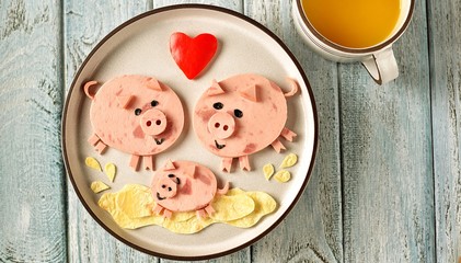 Cute family of pigs food art idea for children's breakfast. symbol of 2019, Top view. 