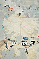 Old grunge ripped torn vintage collage street posters creased crumpled paper surface placard texture background backdrop empty space for text