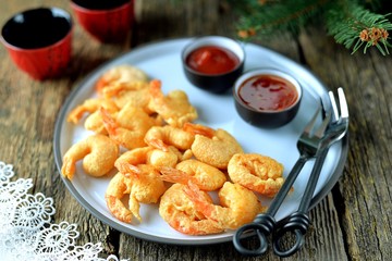 Crispy fried shrimp tails with sauces.
