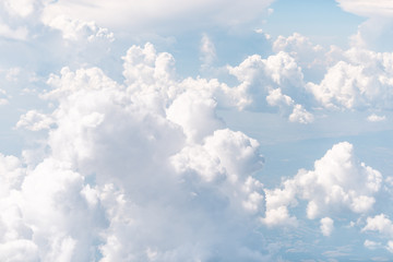 Isolated sky cloudscape with fluffy clouds and bright soft sunny sunlight aerial view of Italy land from airplane