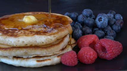 Eating a Stack of Pancakes with Syrup and Blueberries