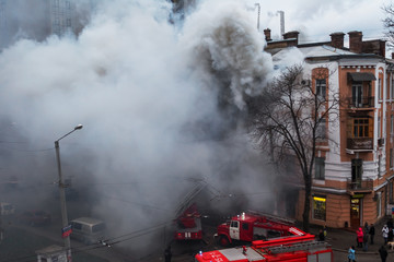 Odessa, Ukraine - Dec. 29, 2016: A fire in an apartment building. Strong bright light and clubs, smoke clouds window of their burning house. Firefighters extinguish fire in house. Work on fire stairs