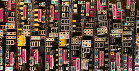 Old computer motherboards. Piles of obsolete hardware and electronic components.