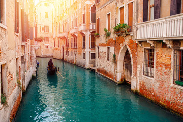 Fototapeta na wymiar Gondolier carries tourists gondola Grand Canal of Venice, Italy.
